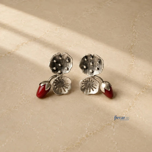pevar925 oxidized 925 silver lotus earrings with vibrant red bead accents and antique finish on a neutral surface