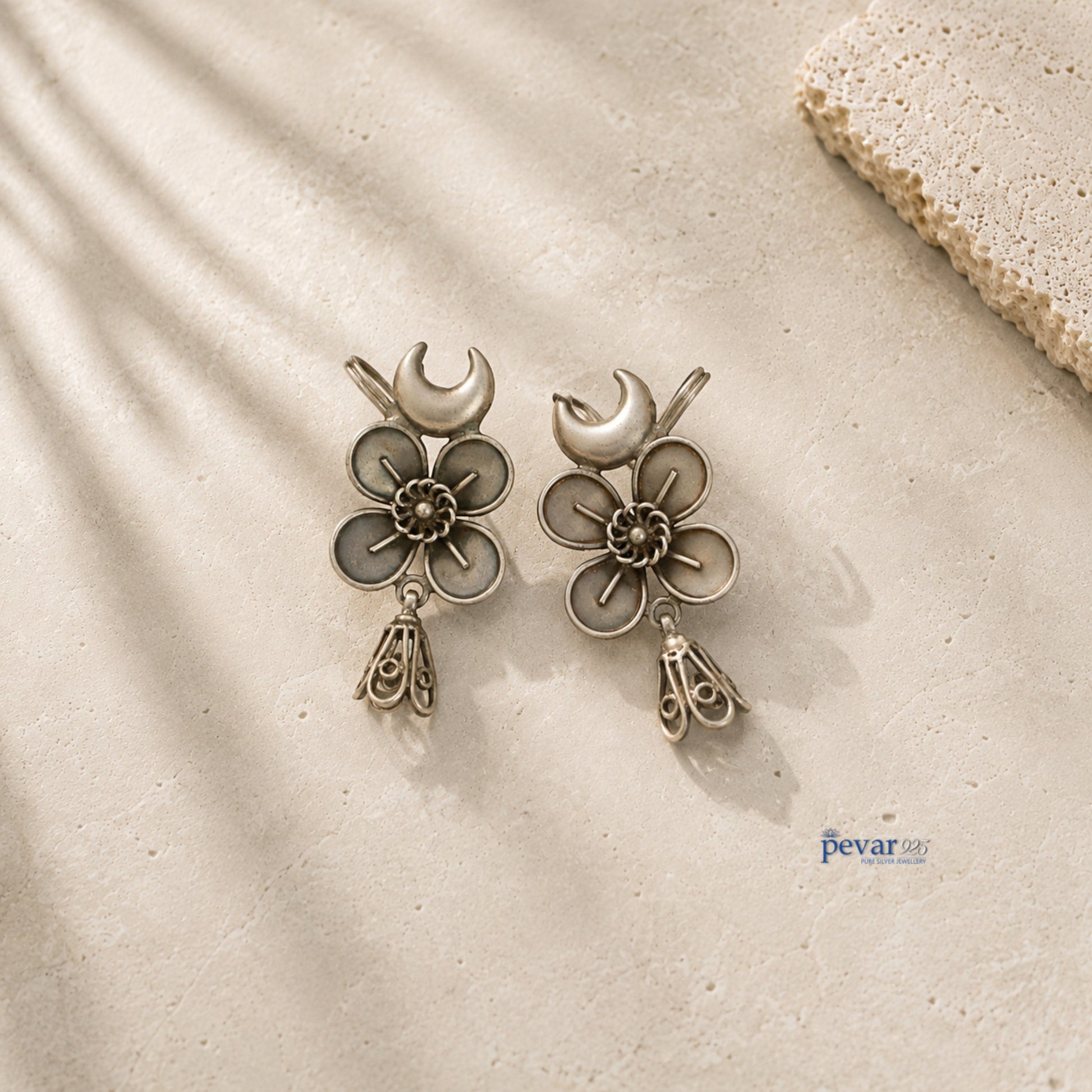 pevar925 oxidized 925 silver ear cuffs featuring crescent moon, floral motifs, and dangling jhumkis on stone surface