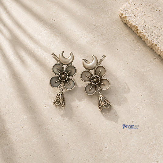 pevar925 oxidized 925 silver ear cuffs featuring crescent moon, floral motifs, and dangling jhumkis on stone surface