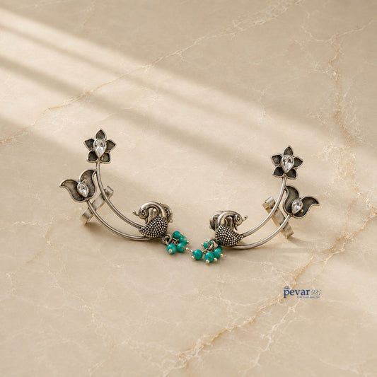 pevar925 oxidized 925 silver earrings featuring intricate peacock and lotus motifs with vibrant turquoise bead accents