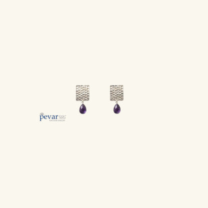 pevar925 oxidized 925 silver earrings featuring hammered rectangular studs with dangling purple teardrop stones.