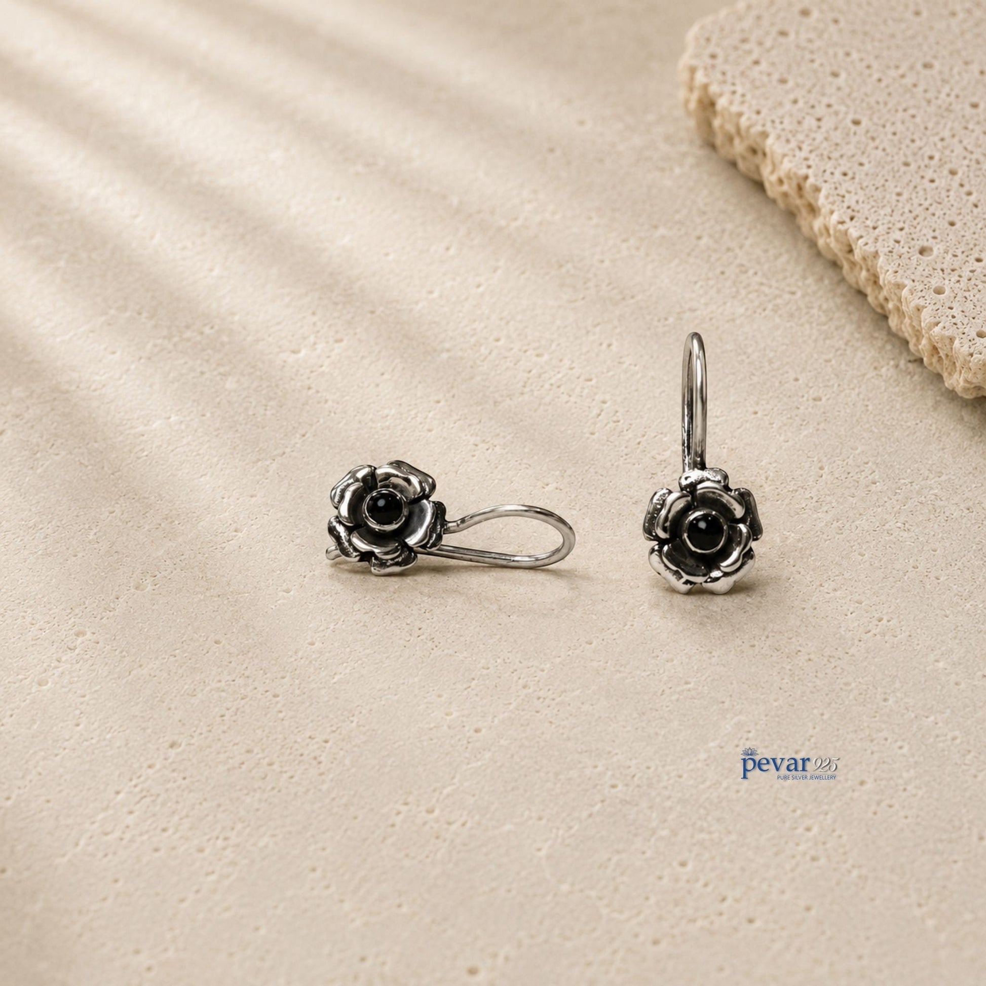 pevar925 oxidized 925 silver drop earrings featuring rose flower motifs with central black stones on a textured surface