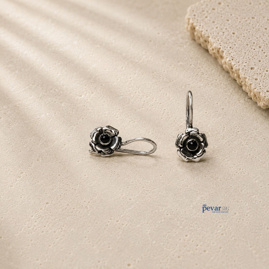pevar925 oxidized 925 silver drop earrings featuring rose flower motifs with central black stones on a textured surface