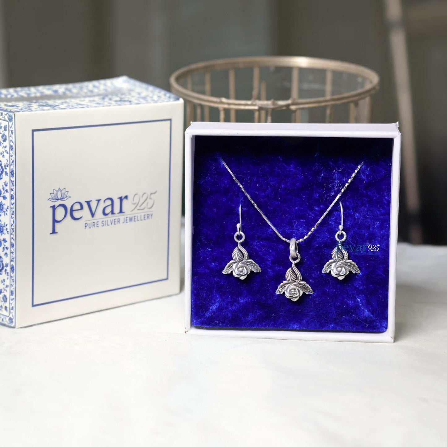 pevar925 oxidized silver rose petal pendant necklace and matching hook earrings in a blue velvet jewelry box