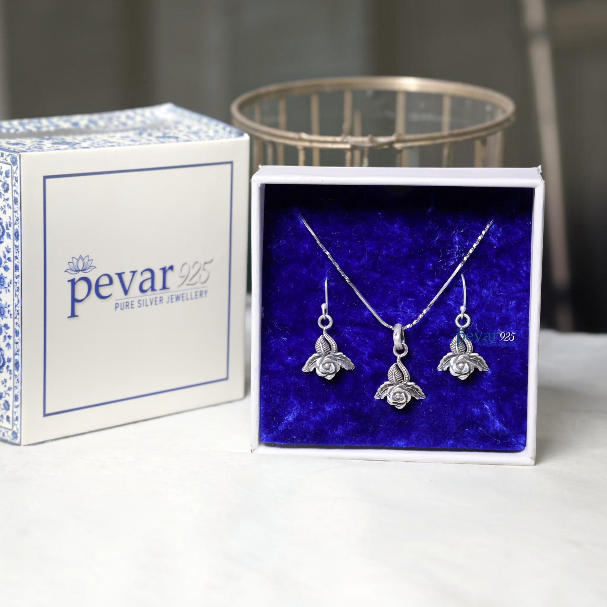 pevar925 oxidized silver rose petal pendant necklace and matching hook earrings in a blue velvet jewelry box