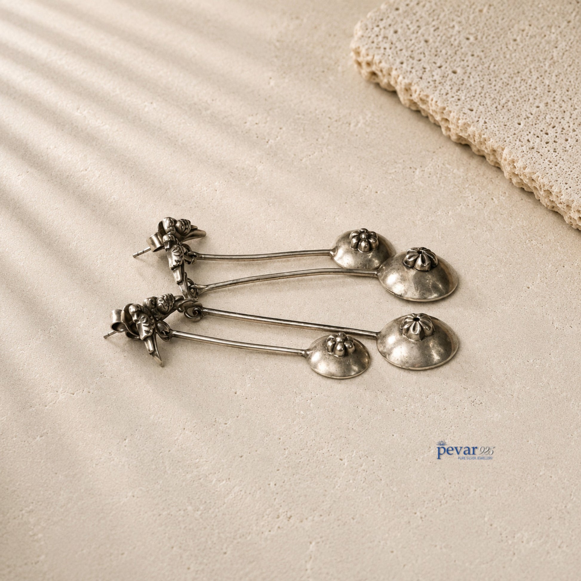 pevar925 oxidized 925 silver sparrow drop earrings with vintage antique finish on a textured beige surface