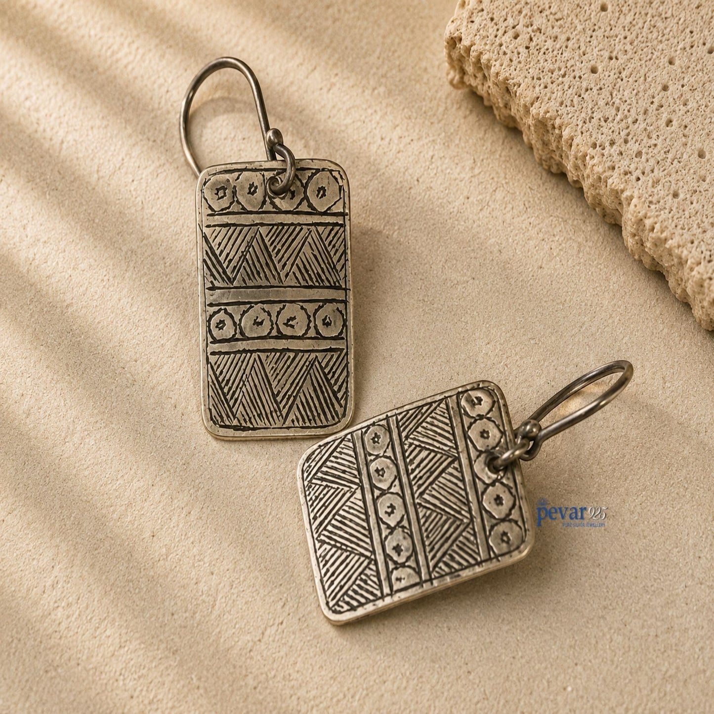 pevar925 oxidized 925 silver square hook earrings with intricate geometric patterns on a textured beige surface