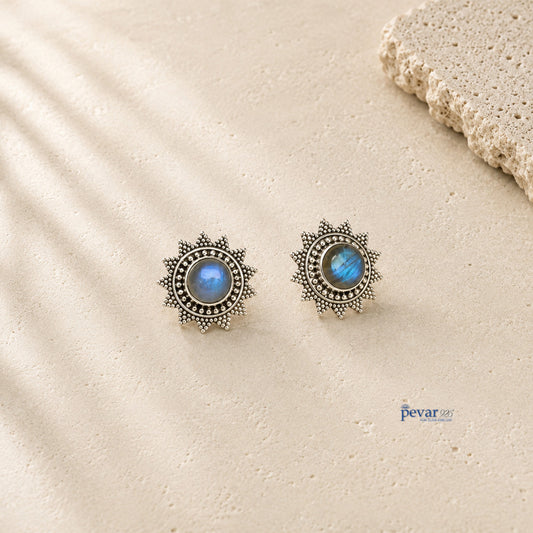 pevar925 oxidized 925 sterling silver stud earrings featuring a blue sunburst stone design on a textured surface