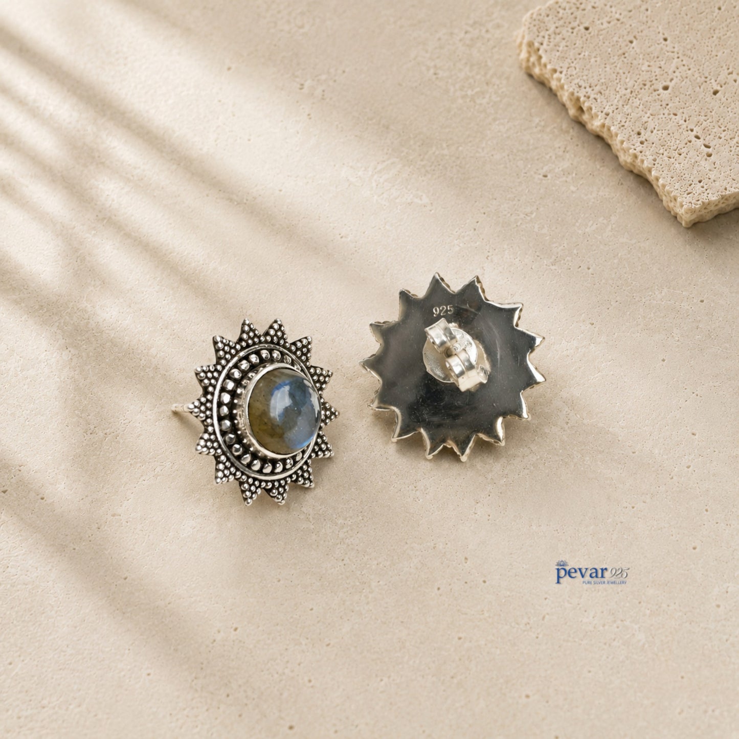 pevar925 oxidized 925 sterling silver sunburst stud earrings featuring a central bluecrom stone on a textured surface