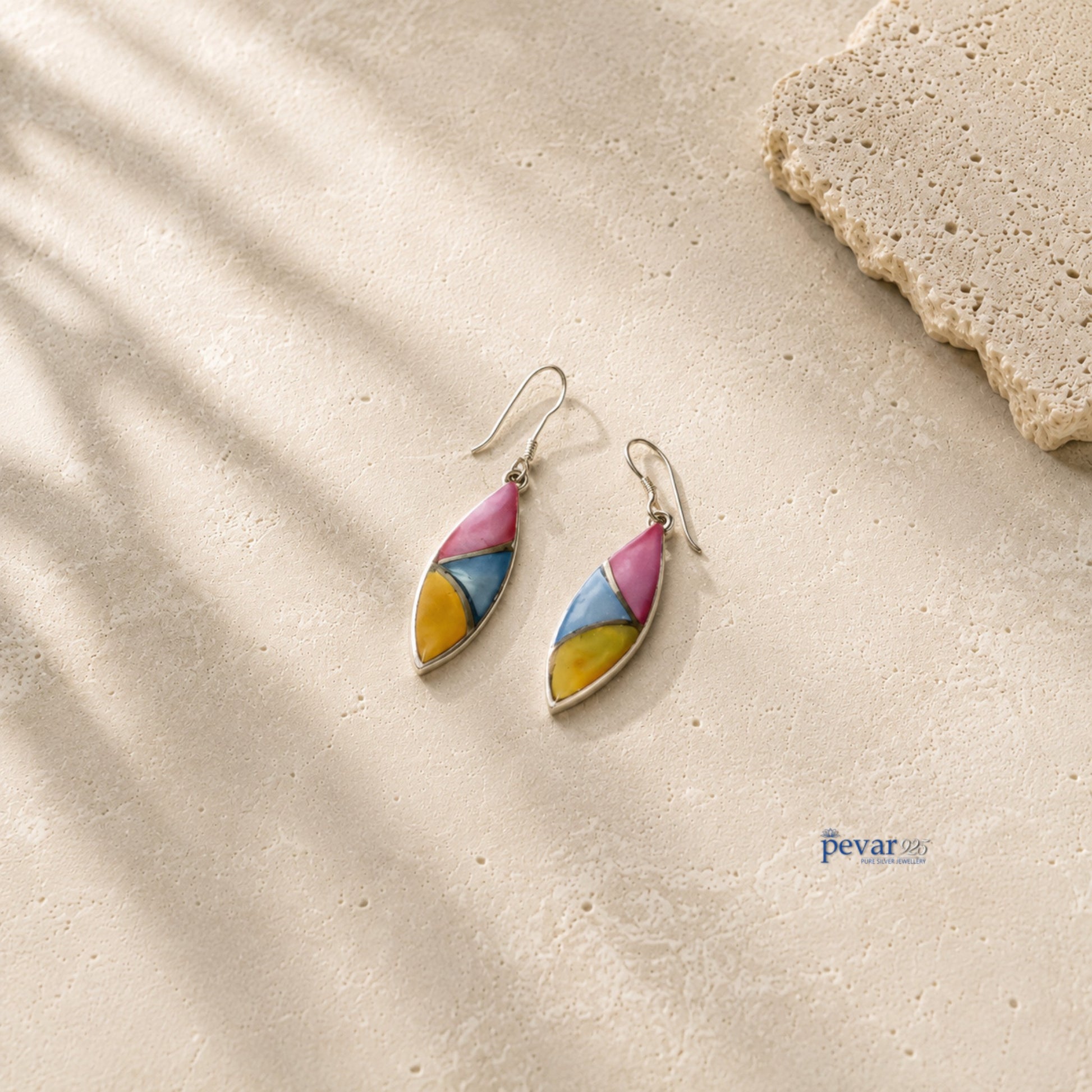 pevar925 oxidized silver hook earrings featuring tri-color leaf motifs in pink, blue, and yellow on a stone surface