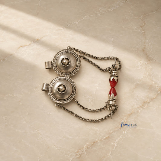 pevar925 oxidized 925 silver tribal earrings featuring intricate circular motifs and red bead accents on a marble surface