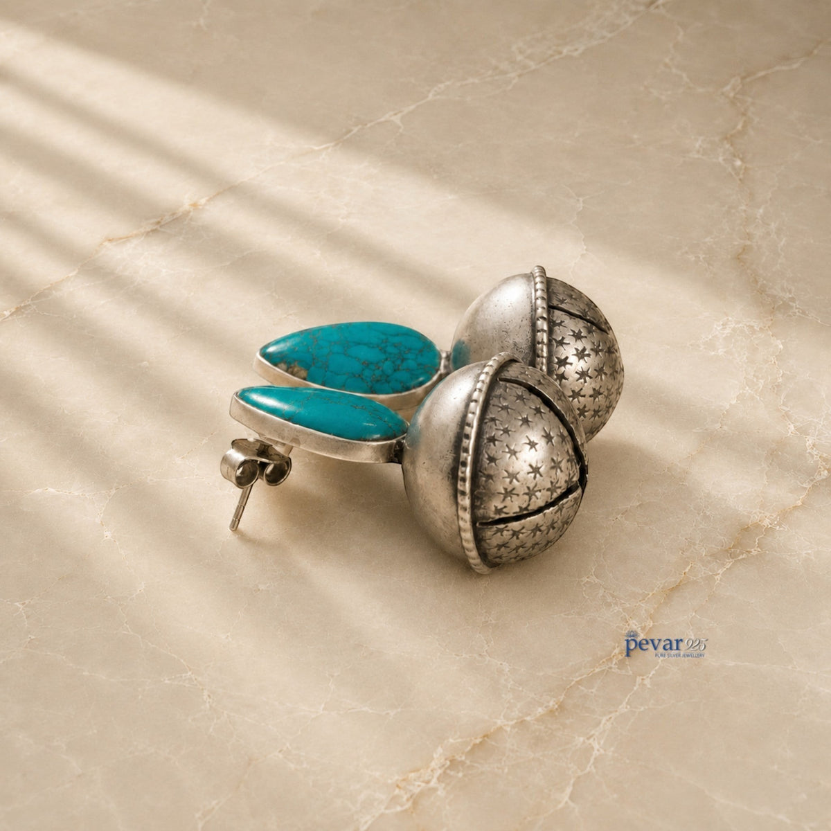 pevar925 oxidized 925 silver bell earrings featuring turquoise stones and star engravings on a marble surface