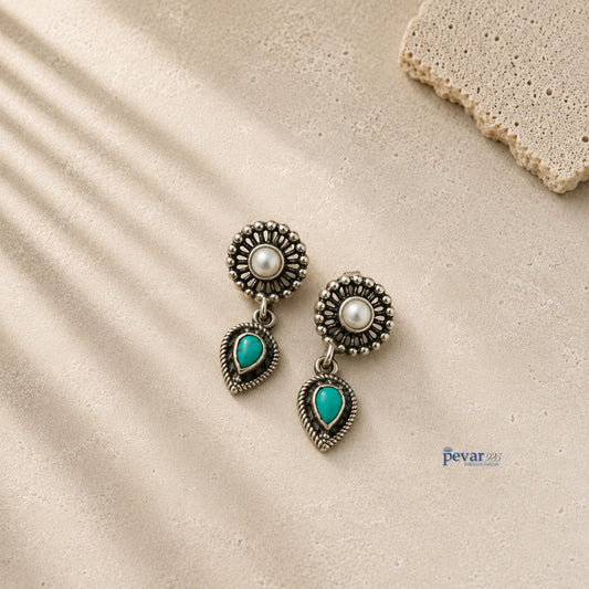 pevar925 oxidized 925 silver earrings featuring a central pearl and a dangling teardrop turquoise stone