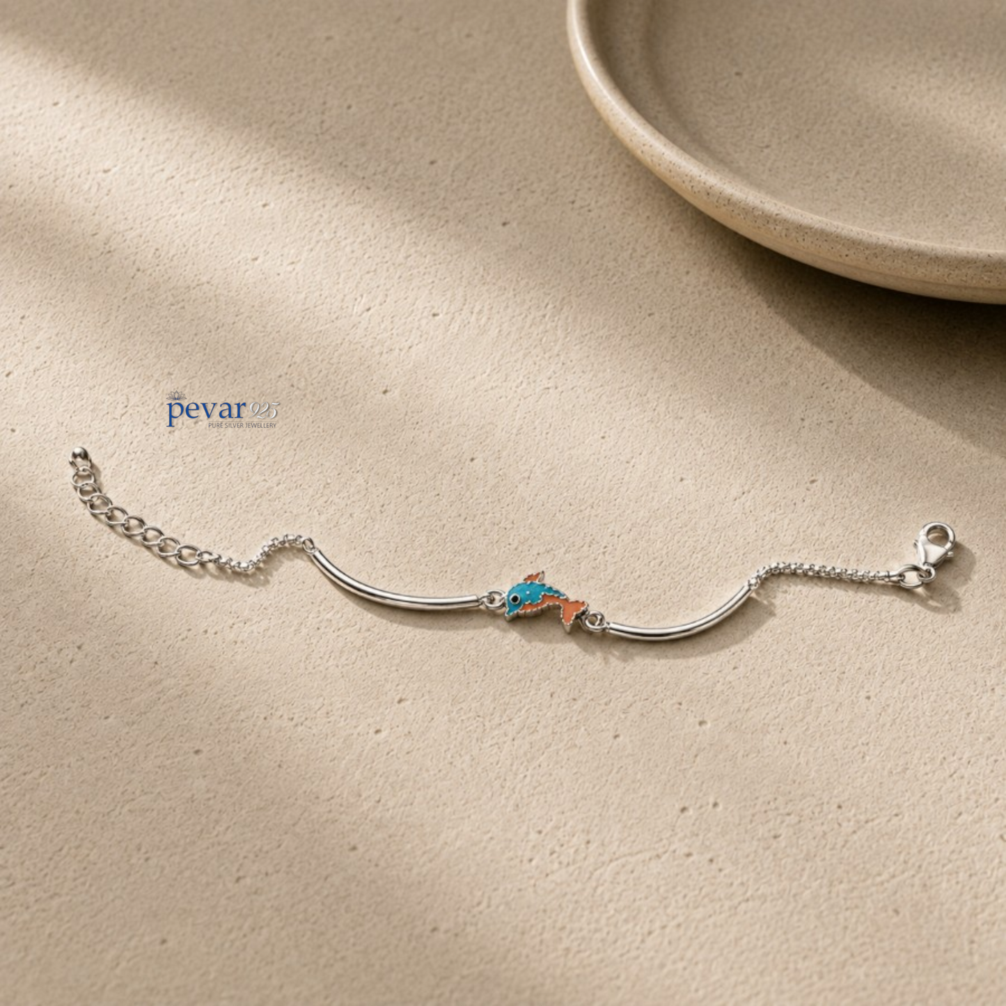 pevar925 sterling silver baby bracelet featuring a small blue and orange dolphin charm on a delicate chain