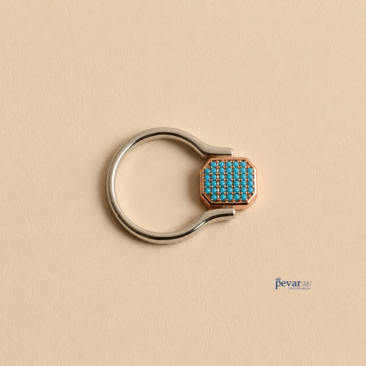 pevar925 sterling silver flip ring with a rectangular top featuring sky-blue stones and rhodium plating