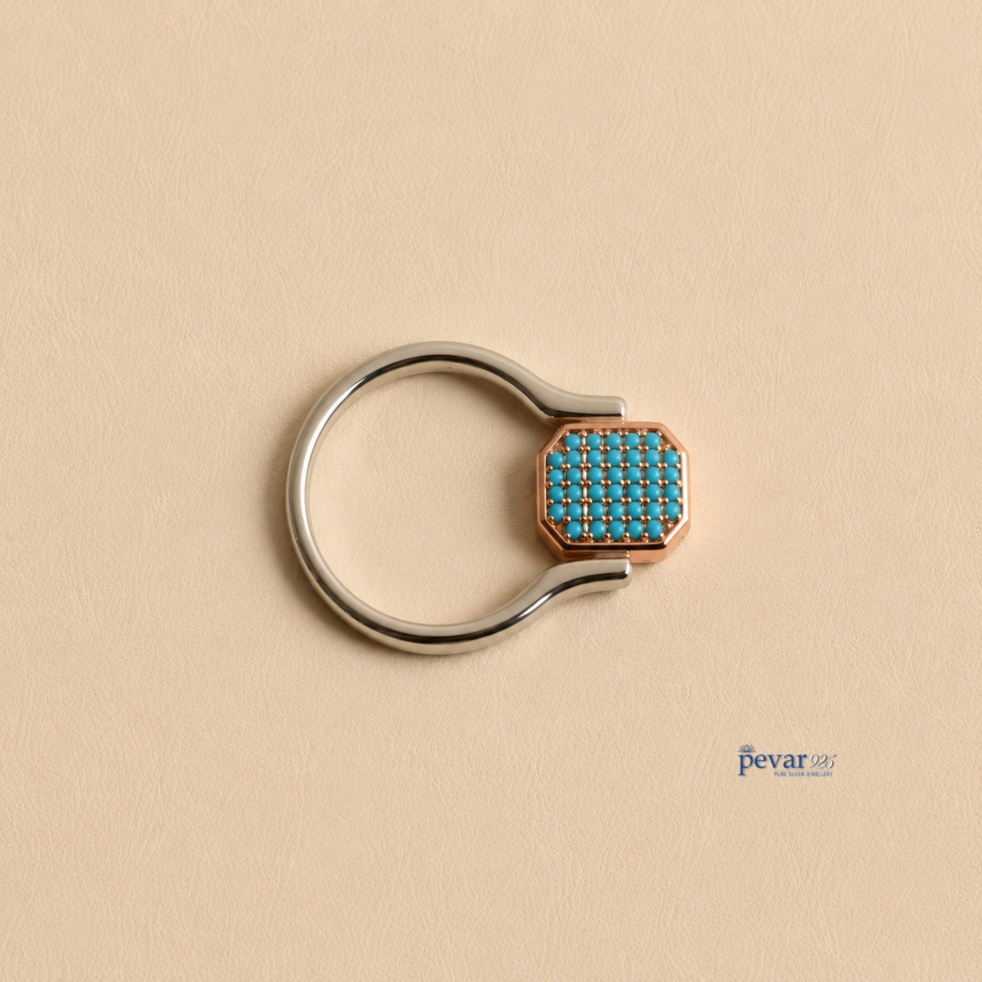 pevar925 sterling silver flip ring with a rectangular top featuring sky-blue stones and rhodium plating