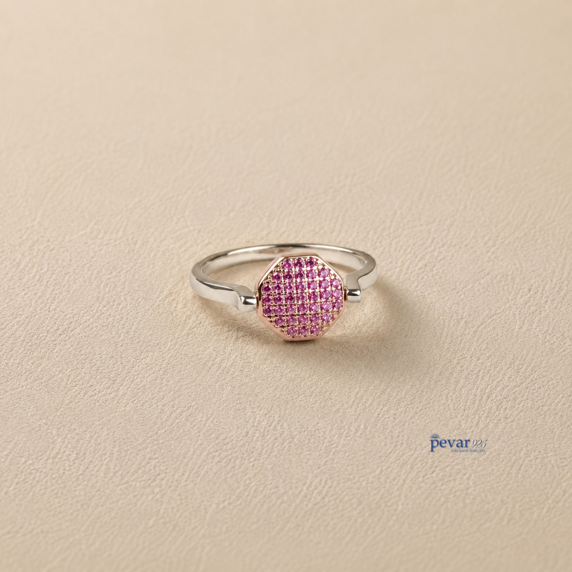 pevar925 sterling silver adjustable flip ring with a pink gemstone hexagon top on a neutral textured background