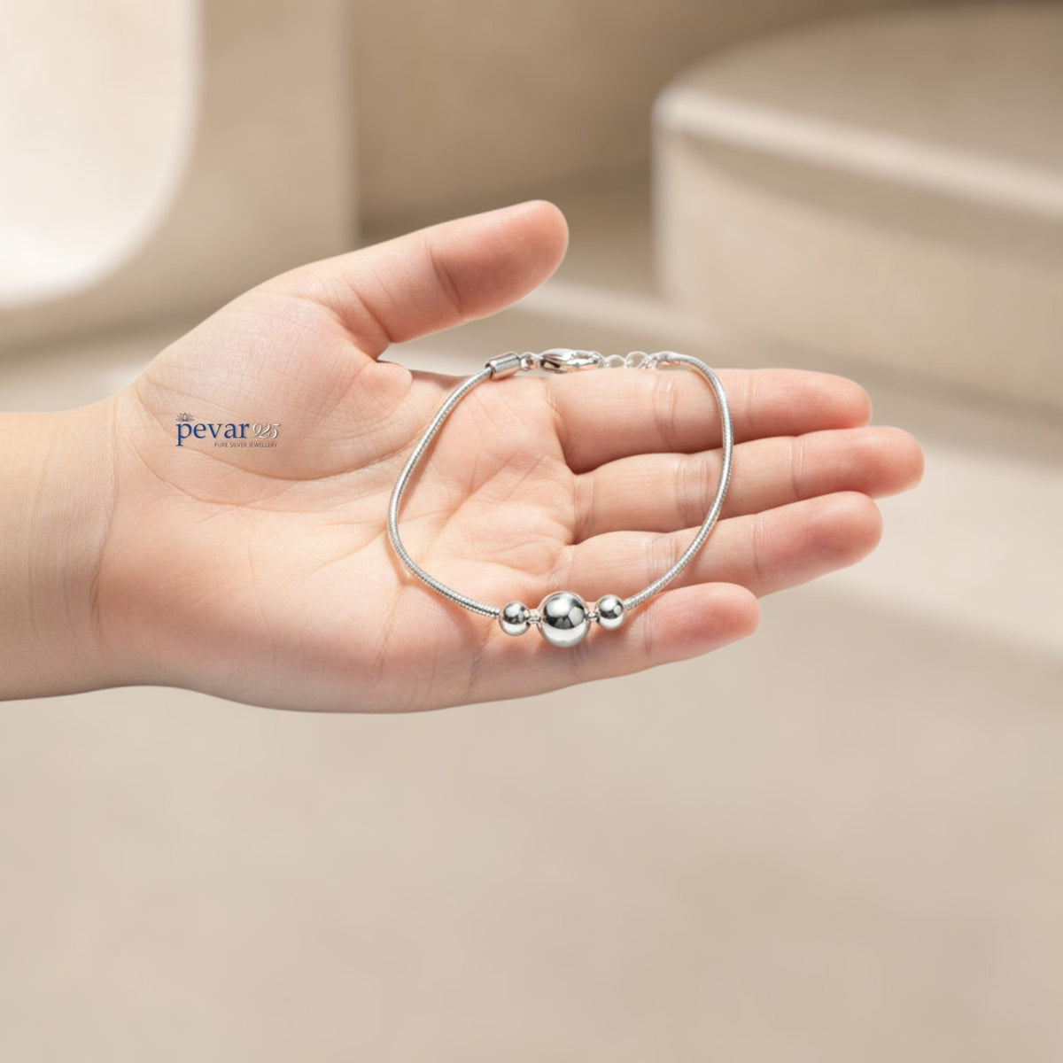 pevar925 sterling silver kids charm bracelet with three polished beads held in a child's hand