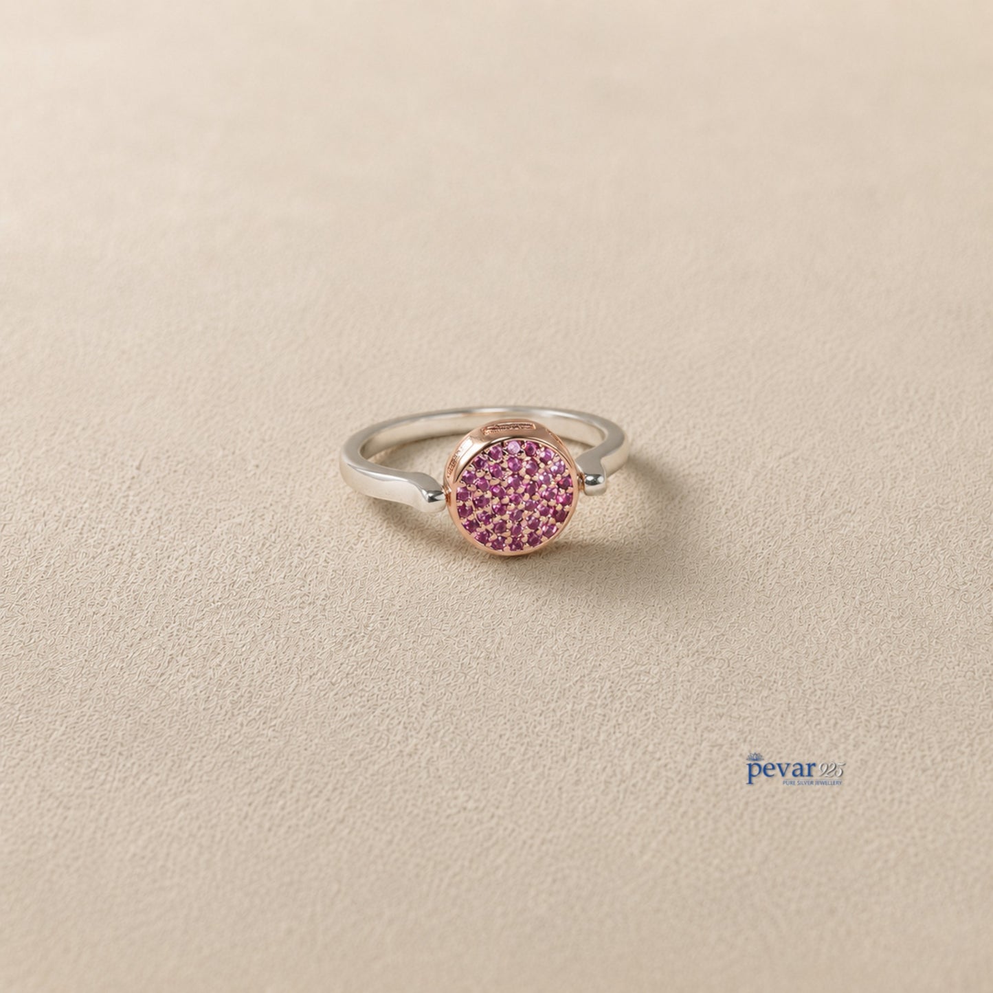 pevar925 sterling silver flip ring with a reversible circular top featuring pink gemstones on a neutral background