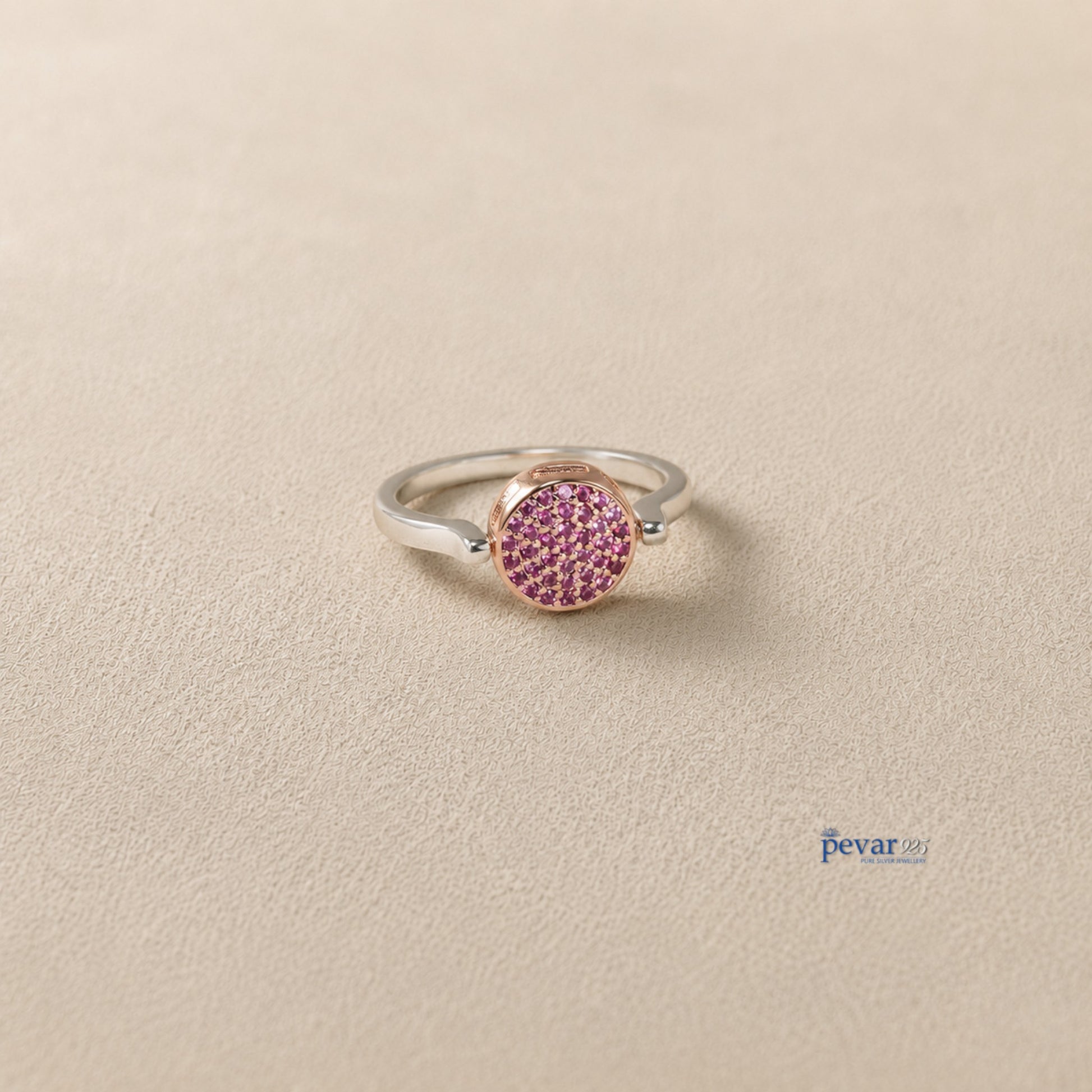 pevar925 sterling silver flip ring with a reversible circular top featuring pink gemstones on a neutral background