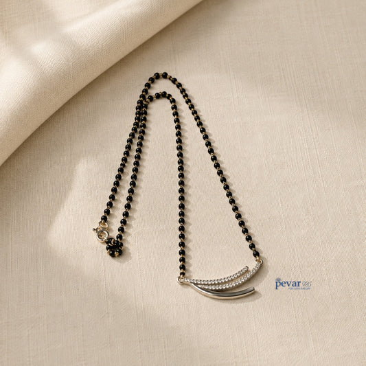 pevar925 sterling silver triple layer mangalsutra with black beads and a rhodium-plated curved motif on beige fabric