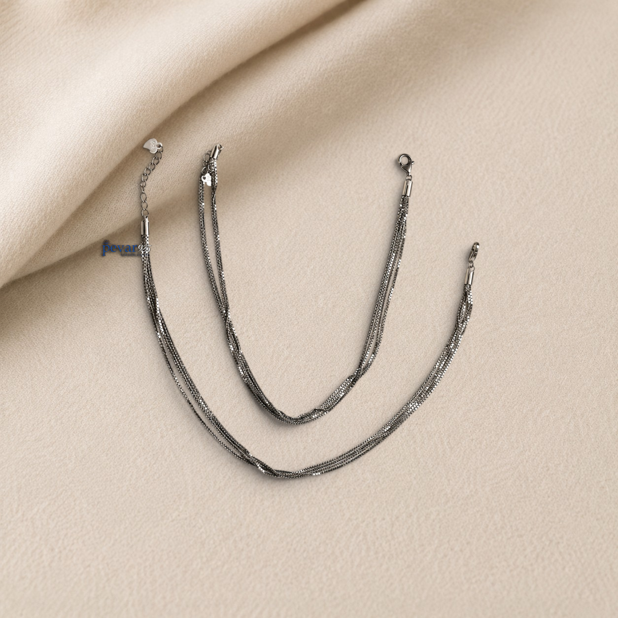 pevar925 sterling silver twisted chain anklet set with rhodium plating and lobster clasp on a beige fabric background