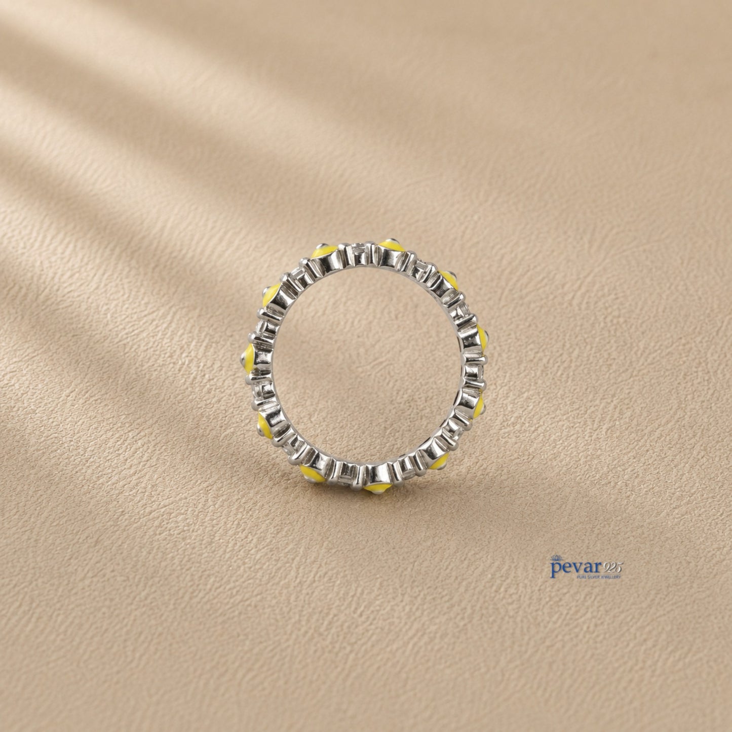 pevar925 sterling silver band ring featuring a continuous row of yellow and black evil eye motifs on rhodium plating.
