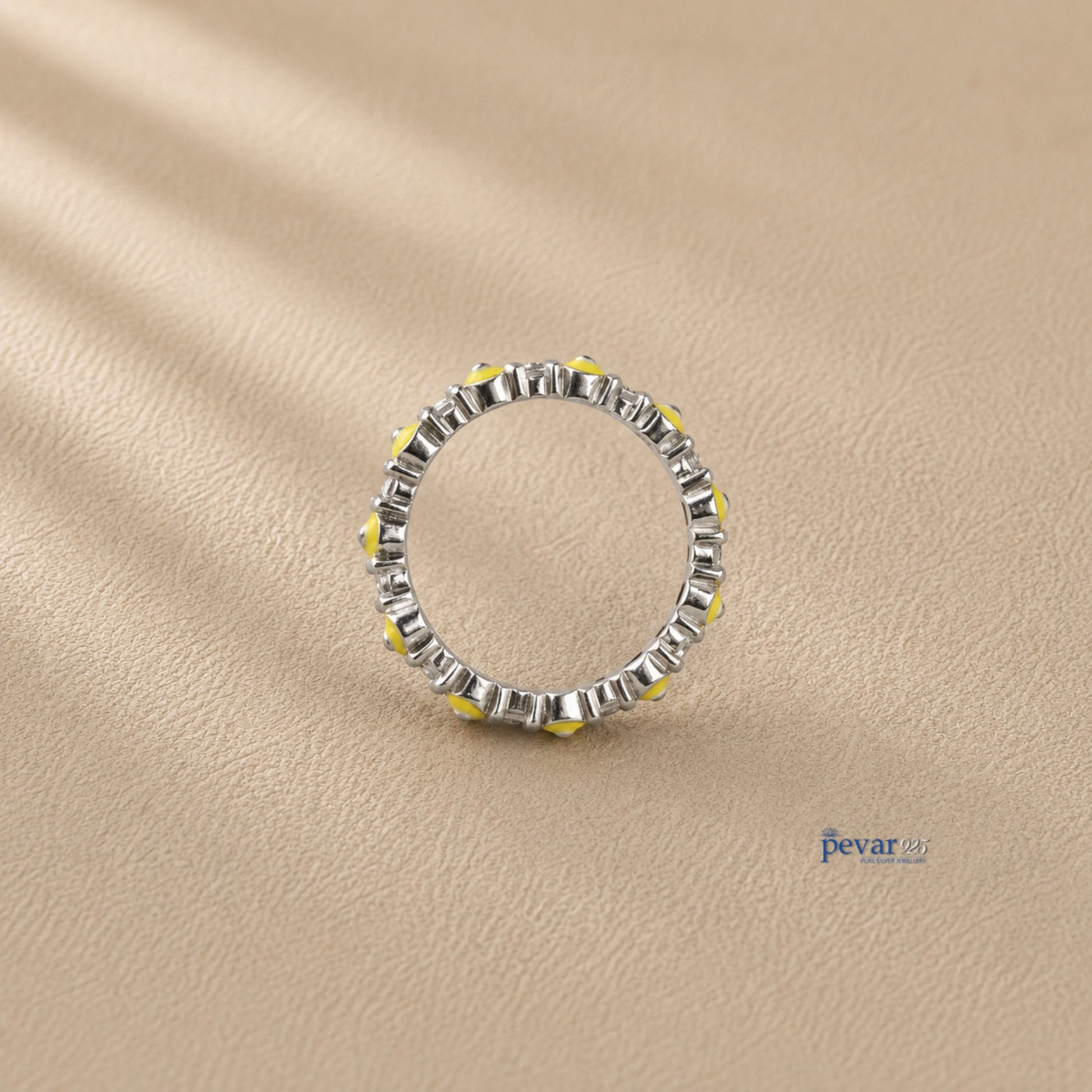 pevar925 sterling silver band ring featuring a continuous row of yellow and black evil eye motifs on rhodium plating.